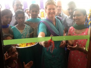 Cutting ribbon whilst being carefully watched!